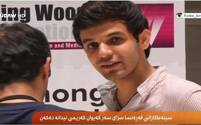 Iranian Kurdish director Kayvan Karimi, 30, faces 6 years in jail and 223 lashes for 'insulting the sacred' for his film 'Writing on the City,' about political slogans daubed on the walls of Tehran's streets. (screen capture: YouTube via Rudaw) Iranian Kurdish director Kayvan Karimi, 30, faces 6 years in jail and 223 lashes for 'insulting the sacred' for his film 'Writing on the City,' about political slogans daubed on the walls of Tehran's streets. (screen capture: YouTube via Rudaw)