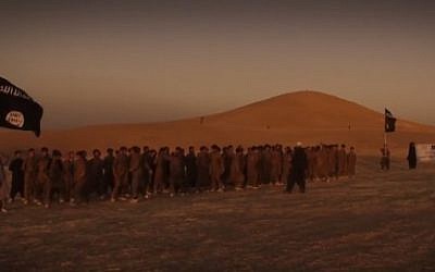Islamic State fighters are seen marching through a desert in a December 2015 video that presents the jihadist group's version of the apocalypse (screen capture) 