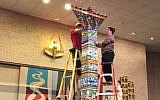 Members of the Texas synagogue Ahavath Sholom put finishing touches on a Lego menorah, Dec. 6, 2015. (Courtesy of Ahavath Sholom via JTA)