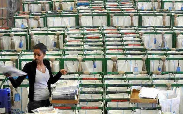 A postal worker stands in the selection hall at a post office in Tel Aviv February, 22, 2010. (Yossi Zeliger/Flash 90) A postal worker stands in the selection hall at a post office in Tel Aviv February, 22, 2010. (Yossi Zeliger/Flash 90)