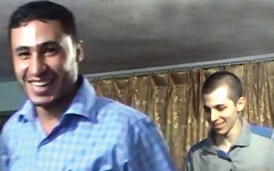 Hamas terrorist Abd al-Rahman al-Mubasar and captured IDF soldier Gilad Shalit in an undated photograph published by Hamas on December 30, 2015. (YouTube/itonline2012)