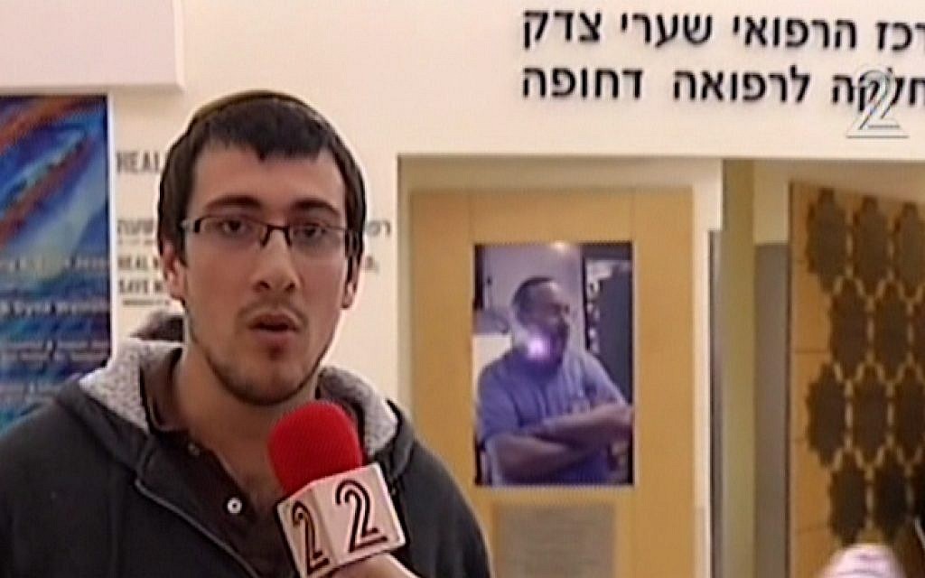 Binyamin Sitbon talks to the media from Shaare Zedek Hospital after his 15-month-old son was wounded in a terror attack at the entrance to Jerusalem, December 14, 2015.  (screen capture: Channel 2)