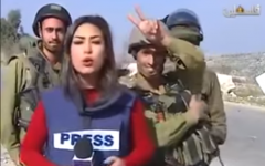 IDF soldiers interrupt the live broadcast of Palestinian journalist Sara Al-Azra, December 14, 2015.  (Screenshot from YouTube)