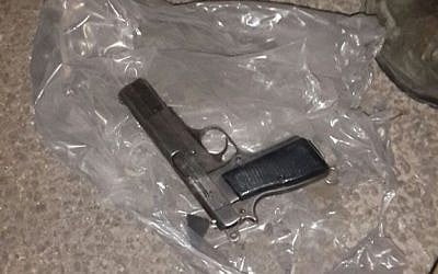 The handgun found by IDF troops hidden inside a car tire at a roadblock east of the Etzion settlement bloc, south of Jerusalem, on December 18, 2015. (Israel Police)