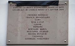 A picture taken on January 5, 2016 shows a memorial plaque bearing the names of the victims of the Charlie Hebdo attack on January 7, 2015. (AFP / JOEL SAGET)
