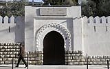 A file photo taken on December 19, 2015 shows a man passing by the entrance to the Al-Ghazali theology institute of the Grand Mosque of Paris. 
(AFP/PATRICK KOVARIK)