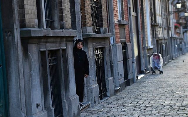 A woman stepping out of an apartment building in the Brussels district of Schaerbeek, January 8, 2016. Belgian police have found three belts for possible use in suicide attacks, traces of explosives, and a fingerprint of wanted Paris attacks suspect Salah Abdeslam at the site, prosecutors said. (AFP/Emmanuel Dunand) A woman stepping out of an apartment building in the Brussels district of Schaerbeek, January 8, 2016. Belgian police have found three belts for possible use in suicide attacks, traces of explosives, and a fingerprint of wanted Paris attacks suspect Salah Abdeslam at the site, prosecutors said. (AFP/Emmanuel Dunand)