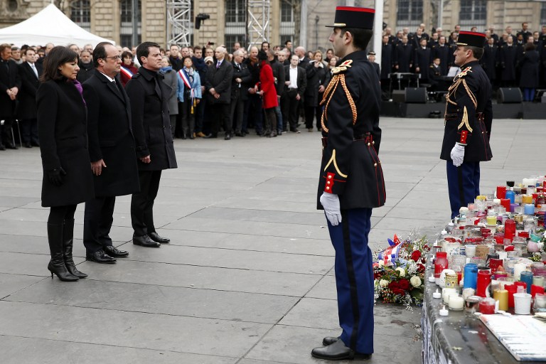 (From L) Mayor of Paris Anne Hidalgo, French President Francois Hollande and French Prime Minister Manuel Valls attend a remembrance rally at Place de la Republique (Republic square) on January 10, 2016 to mark a year since 1.6 million people thronged the French capital in a show of unity after attacks on the Charlie Hebdo newspaper and a Jewish supermarket. (AFP / POOL / YOAN VALAT)
