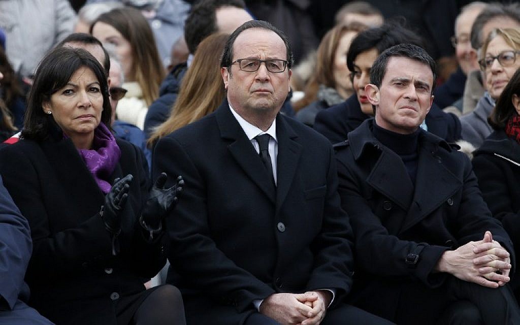 (From L) French Paris' Mayor Anne Hidalgo, French President Francois Hollande and French Prime Minister Manuel Valls attend a remembrance rally at Place de la Republique (Republic square) on January 10, 2016 to mark a year since 1.6 million people thronged the French capital in a show of unity after attacks on the Charlie Hebdo newspaper and a Jewish supermarket.
(AFP / POOL / YOAN VALAT)