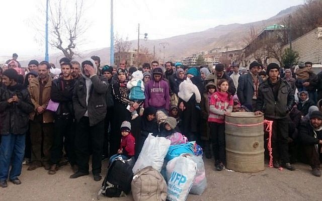 Syrians wait for the arrival of an aid convoy on January 11, 2016, in the besieged town of Madaya as part of a landmark six-month deal reached in September 2015 for an end to hostilities in those areas in exchange for humanitarian assistance. (AFP/Stringer) Syrians wait for the arrival of an aid convoy on January 11, 2016, in the besieged town of Madaya as part of a landmark six-month deal reached in September 2015 for an end to hostilities in those areas in exchange for humanitarian assistance. (AFP/Stringer)