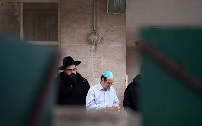 People stand in fron of the 'La Source' Jewish school in Marseille, southern France, on January 11, 2016, after a Jewish teacher was attacked by a teenager wielding a machete. (AFP / BERTRAND LANGLOIS)