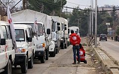 A convoy of aid from the International Committee of the Red Cross (ICRC) waits on the outskirts of the besieged rebel-held Syrian town of Madaya, on January 11, 2016. (AFP/Louai Beshara)