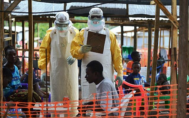 This file photo taken on August 15, 2014 shows a Doctors Without Borders (MSF) medical worker wearing protective clothing while speaking to a colleague at an MSF facility in Kailahun, Sierra Leone. (Carl de Souza/AFP) This file photo taken on August 15, 2014 shows a Doctors Without Borders (MSF) medical worker wearing protective clothing while speaking to a colleague at an MSF facility in Kailahun, Sierra Leone. (Carl de Souza/AFP)