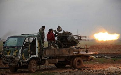 Syrian regime forces fire towards Islamic State (IS) jihadists south of the town of al-Bab, in the northern province of Aleppo on January 14, 2016. (AFP/George Ourfalian)