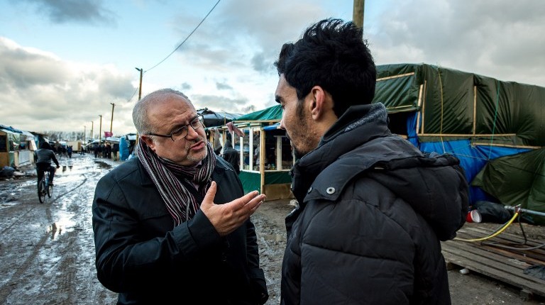OFPRA Deputy Director Mourad Derbak (L) speaks with an Afghan migrant during a roam by members of The French Office for the Protection of Refugees and Stateless Persons (OFPRA), at the Jungle migrant camp in Calais, on January 14, 2016. (Philippe Huguen/AFP) OFPRA Deputy Director Mourad Derbak (L) speaks with an Afghan migrant during a roam by members of The French Office for the Protection of Refugees and Stateless Persons (OFPRA), at the Jungle migrant camp in Calais, on January 14, 2016. (Philippe Huguen/AFP)