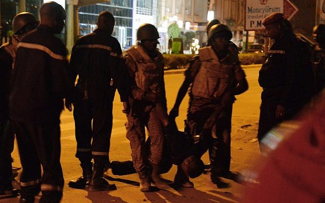 Burkinabe soldiers carry the body of a man in the surroundings of the Splendid Hotel during an attack on both the hotel and a restaurant by al-Qaeda linked gunmen early on January 16, 2016. (AFP/AHMED OUOBA) Burkinabe soldiers carry the body of a man in the surroundings of the Splendid Hotel during an attack on both the hotel and a restaurant by al-Qaeda linked gunmen early on January 16, 2016. (AFP/AHMED OUOBA)