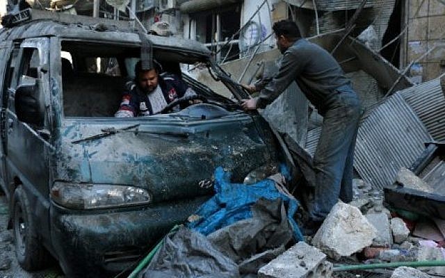 Syrian men inspect a damaged vehicle in the rubble following a reported air strike by Syrian government forces on the Sukkari neighborhood of Syria's northern city of Aleppo, on January 16, 2016. (AFP/Karam Al-Masri) Syrian men inspect a damaged vehicle in the rubble following a reported air strike by Syrian government forces on the Sukkari neighborhood of Syria's northern city of Aleppo, on January 16, 2016. (AFP/Karam Al-Masri)