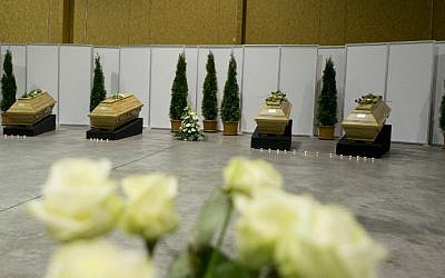 Coffins with the remains of ten German tourists killed in a suicide bomb attack at Istanbul's historic Sultanahmet district are laid out in a hangar at Berlin's Tegel Airport after they were repatriated on January 16, 2016. (Axel Schmidt/Pool/AFP)