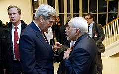 US Secretary of State John Kerry (left) speaks with Iranian Foreign Minister Mohammad Javad Zarif after the UN atomic watchdog verifies that Iran has met all conditions of the July 2015 nuclear deal, in Vienna, Austria, on January 16, 2016. (AFP/Kevin Lamarque/Pool)