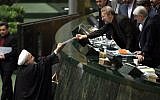 Iranian President Hassan Rouhani, left, presents the proposed annual budget to Parliament Speaker Ali Larijani Ali Larijani in the capital Tehran, on January 17, 2016, after sanctions were lifted under Tehran's nuclear deal with world powers. (AFP/Atta Kenare)