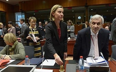 EU Foreign Affairs chief Federica Mogherini, center, rings the bell during a EU Foreign Affairs Council meeting at EU headquarters in Brussels, on January 18, 2016. (AFP/John Thys)
