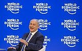 Prime Minister Benjamin Netanyahu laughs during a conference at the World Economic Forum (WEF) annual meeting in Davos,  on January 21, 2016. (AFP/FABRICE COFFRINI)