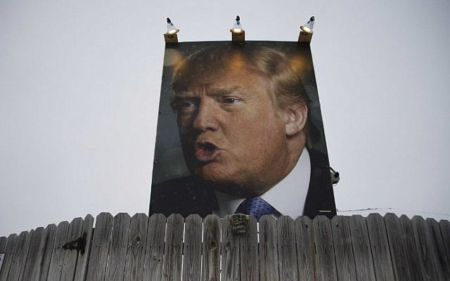 A giant poster of Republican presidential candidate Donald Trump stands on display in the backyard of supporter George Davey's residence in West Des Moines, Iowa, January 25, 2016, ahead of the Iowa Caucus. (Jim Watson/AFP) A giant poster of Republican presidential candidate Donald Trump stands on display in the backyard of supporter George Davey's residence in West Des Moines, Iowa, January 25, 2016, ahead of the Iowa Caucus. (Jim Watson/AFP)