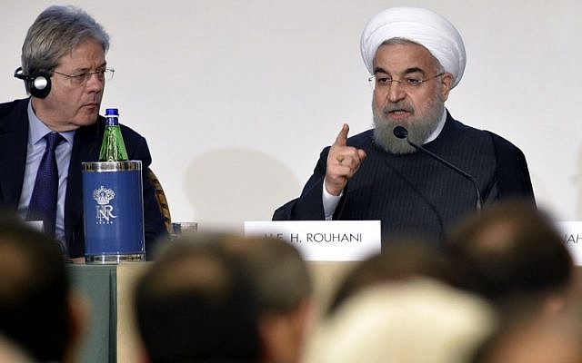 Iranian President Hassan Rouhani, right, gestures next to Italy's Foreign Minister Paolo Gentiloni as they attend an Iran-Italy business forum in Rome on January 26, 2016. (AFP / ANDREAS SOLARO) Iranian President Hassan Rouhani, right, gestures next to Italy's Foreign Minister Paolo Gentiloni as they attend an Iran-Italy business forum in Rome on January 26, 2016. (AFP / ANDREAS SOLARO)