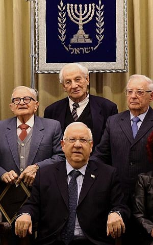 President President Reuven Rivlin (C) poses for a group picture with former judge Gabriel Bach (C-top), former minister Rafi Eitan (L-top) and Mickey Goldman, who was a member of a special police unit (Bureau 06) during a ceremony at the presidential compound in Jerusalem marking 55 years since the trial of Nazi war criminal Adolf Eichmann, on January 27, 2016. (AFP/GALI TIBBON)