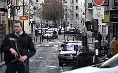 French policemen stand guard at Rue de la Goutte d'Or in the north of Paris on January 7, 2016, near the site where police shot a knife-wielding man dead as he was trying to enter a police station (Alain Jocard/AFP)