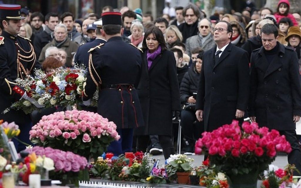 French Paris' mayor Anne Hidalgo, French President Francois Hollande, and French Prime minister Manuel Valls, attend a remembrance rally at Place de la Republique (Republic square) on January 10, 2016 in Paris, a year after attacks on the Charlie Hebdo newspaper and a Jewish supermarket. (AFP PHOTO / THOMAS SAMSON)