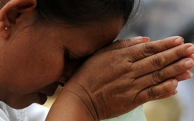 A Sri Lankan Buddhist worshipper prays at a temple in Colombo on January 1, 2016 to welcome in the New Year. (AFP Photo/Lakruwan Wanniarachchi) A Sri Lankan Buddhist worshipper prays at a temple in Colombo on January 1, 2016 to welcome in the New Year. (AFP Photo/Lakruwan Wanniarachchi)