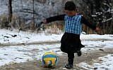 Afghan boy and Lionel Messi fan Murtaza Ahmadi, 5, wears a plastic bag jersey as he plays soccer in Jaghori district of Ghazni province on January 29, 2016. (AFP)