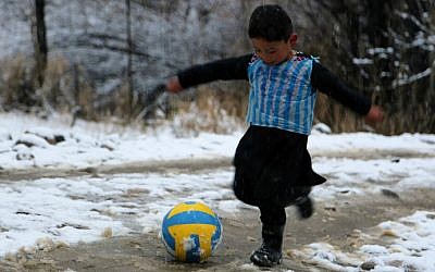 Afghan boy and Lionel Messi fan Murtaza Ahmadi, 5, wears a plastic bag jersey as he plays soccer in Jaghori district of Ghazni province on January 29, 2016. (AFP)