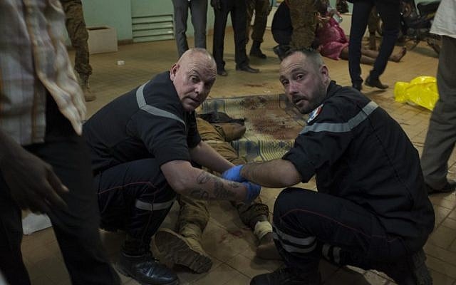 French first responders tend to wounded people in the surrounding of the Hotel Splendide and the Café Cappuccino during the attack on January 15, 2016. (AFP PHOTO/NABILA EL HADAD) French first responders tend to wounded people in the surrounding of the Hotel Splendide and the Café Cappuccino during the attack on January 15, 2016. (AFP PHOTO/NABILA EL HADAD)