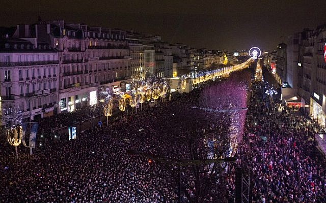 People gather on the Champs-Elysees before celebrating the New Year in Paris on December 31, 2015. (AFP Photo/Florian David) People gather on the Champs-Elysees before celebrating the New Year in Paris on December 31, 2015. (AFP Photo/Florian David)