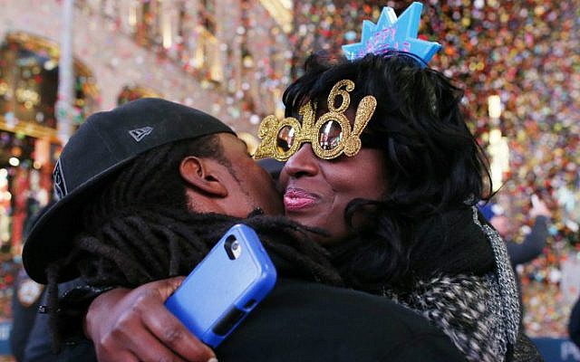 Revelers hug after the ball drops during New Year's Eve celebrations in Times Square on January 1, 2016 in New York. (AFP Photo/Kena Betancur) Revelers hug after the ball drops during New Year's Eve celebrations in Times Square on January 1, 2016 in New York. (AFP Photo/Kena Betancur)