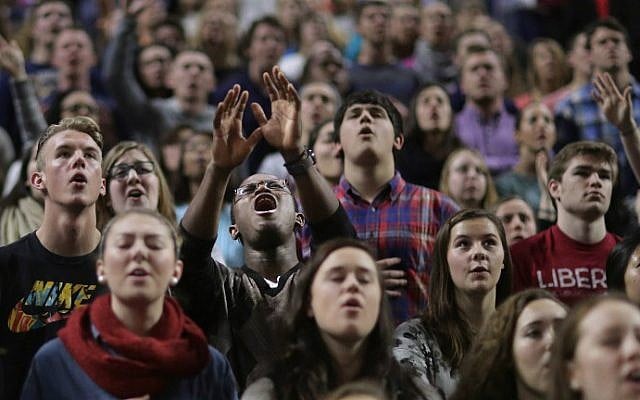 Thousands of students, supporters and invited guests sing songs of Christian praise before Republican presidential candidate Donald Trump delivers the convocation in the Vines Center on the campus of Liberty University, January 18, 2016 in Lynchburg, Virginia. (Chip Somodevilla/Getty Images/AFP) Thousands of students, supporters and invited guests sing songs of Christian praise before Republican presidential candidate Donald Trump delivers the convocation in the Vines Center on the campus of Liberty University, January 18, 2016 in Lynchburg, Virginia. (Chip Somodevilla/Getty Images/AFP)