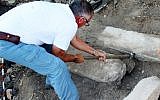 Aharoni Amitai near the inscriptions that were uncovered, January 26, 2016 (Miki Peleg, courtesy of the Israel Antiquities Authority)