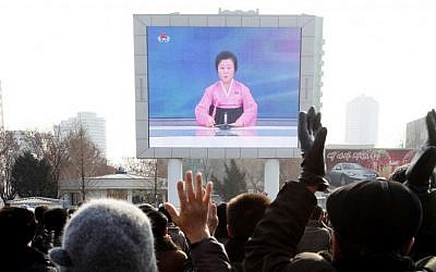 North Koreans watch a news broadcast on a video screen outside Pyongyang Railway Station in Pyongyang, North Korea, January 6, 2016. (AP/Kim Kwang Hyon)