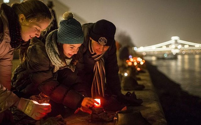 File: Backdropped by the illuminated Chain Bridge, people light candles in front of the cast iron shoes at the Holocaust Memorial on the quay of the River Danube, during International Holocaust Remembrance Day in Budapest, Hungary, Wednesday, Jan. 27, 2016. (Balazs Mohai/MTI via AP) File: Backdropped by the illuminated Chain Bridge, people light candles in front of the cast iron shoes at the Holocaust Memorial on the quay of the River Danube, during International Holocaust Remembrance Day in Budapest, Hungary, Wednesday, Jan. 27, 2016. (Balazs Mohai/MTI via AP)