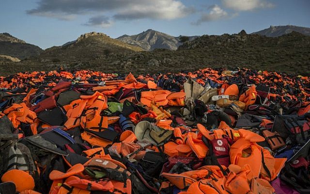 Piles of life jackets used by refugees and migrants to cross the Aegean Sea from the Turkish coast remain stacked on the Greek island of Lesbos, December 2, 2015. (AP/Santi) Piles of life jackets used by refugees and migrants to cross the Aegean Sea from the Turkish coast remain stacked on the Greek island of Lesbos, December 2, 2015. (AP/Santi)
