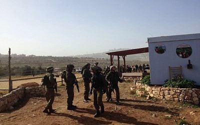 IDF soldiers near the scene of a stabbing attack in the West Bank settlement of Tekoa on Monday, January 18, 2016. (Joshua Davidovich/Times of Israel)