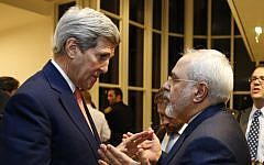 US Secretary of State John Kerry, left, talks with Iranian Foreign Minister Mohammad Javad Zarif, right, in Vienna, Austria, on January 16, 2016. (Kevin Lamarque/Pool via AP)
