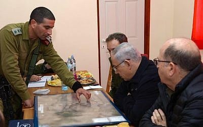 Prime Minister Benjamin Netanyahu, center, and then-defense minister Moshe Ya'alon, right,  during a visit to the settlement of Otniel in the West Bank, January 19, 2016. (Government Press Office)