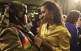 Wheaton College professor Larycia Hawkins, right, is greeted by supporter Donna Demir after a news conference Wednesday, Jan. 6, 2016, in Chicago. (AP Photo/M. Spencer Green)