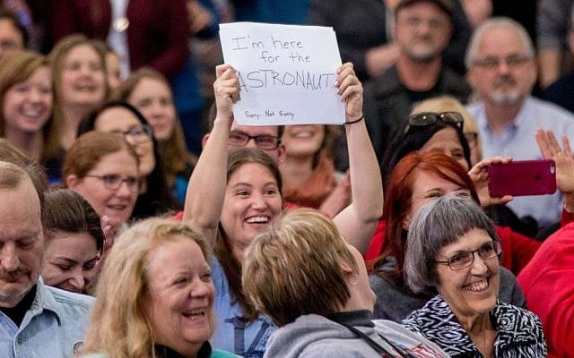 A woman in the audience holds a sign that reads "I'm here for the astronaut" as former Arizona Rep. Gabby Giffords and her husband Mark Kelly joins Democratic presidential candidate Hillary Clinton for a rally at Iowa State University in Ames, Iowa Saturday, Jan. 30, 2016. (AP Photo/Andrew Harnik) A woman in the audience holds a sign that reads "I'm here for the astronaut" as former Arizona Rep. Gabby Giffords and her husband Mark Kelly joins Democratic presidential candidate Hillary Clinton for a rally at Iowa State University in Ames, Iowa Saturday, Jan. 30, 2016. (AP Photo/Andrew Harnik)