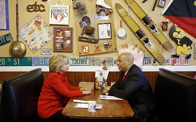 Democratic presidential candidate Hillary Clinton, left, chats with Sen. Cory Booker, D-N.J., at Riley's Cafe in Cedar Rapids, Iowa, Sunday, Jan. 24, 2016. (AP Photo/Patrick Semansky) 