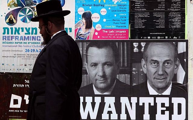 A mock "Wanted" poster in Jerusalem shows former prime ministers Ehud Olmert and Ehud Barak, April 15, 2010. (Abir Sultan/Flash 90) A mock "Wanted" poster in Jerusalem shows former prime ministers Ehud Olmert and Ehud Barak, April 15, 2010. (Abir Sultan/Flash 90)