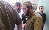Corporal Elad Yaakov Sela from the Bat Ayin settlement is brought to court in Tel Aviv on April 13, 2015. (Flash90)